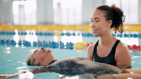 aquatic therapy session with a senior and therapist in a pool