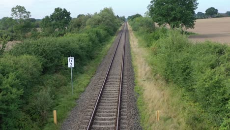 a drone flies in good weather at a very low altitude over railway tracks