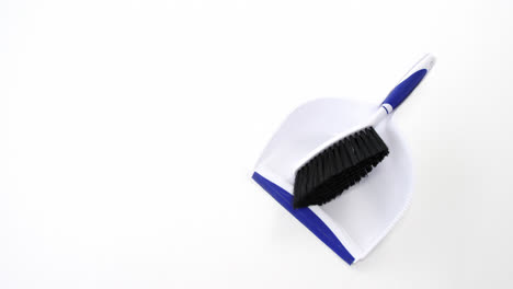 Dustpan-and-sweeping-brush-on-white-background