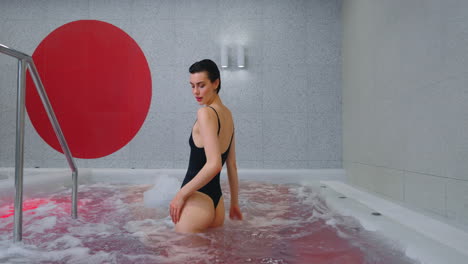 woman enjoying a spa experience in a modern hot tub