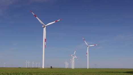 long shadow under windmill, large wind power turbines spinning to generating clean, green, renewable energy