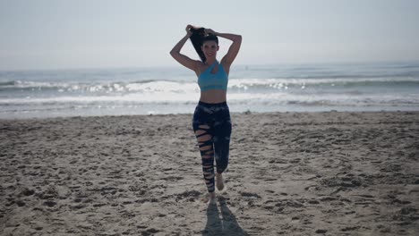 woman on the beach exercising