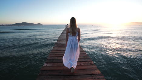 Girl-walks-down-the-bridgte-to-the-Sea-of-Mallorca