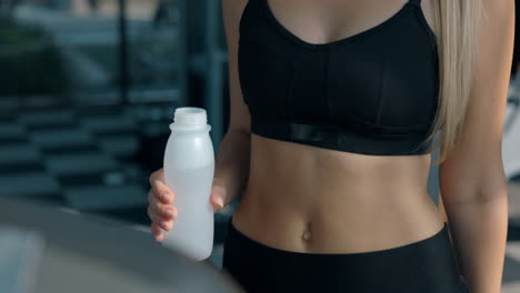 a person holding a water bottle in a gym