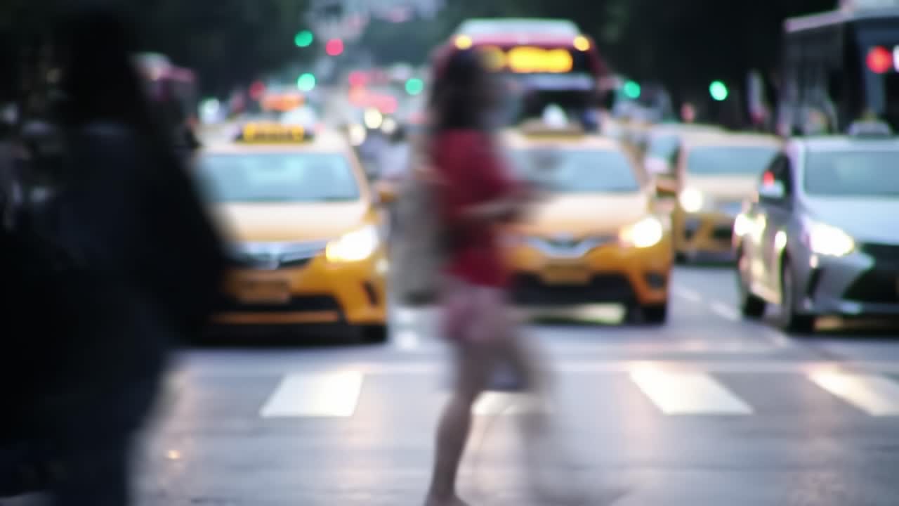 A bustling urban intersection comes alive as taxis, buses, and bicycles move through the evening rush hour while pedestrians navigate the busy street, creating a vibrant city atmosphere.