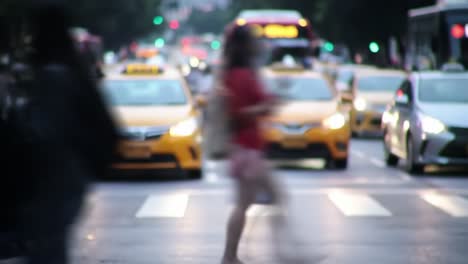 a bustling urban intersection comes alive as taxis, buses, and bicycles move through the evening rush hour while pedestrians navigate the busy street, creating a vibrant city atmosphere.