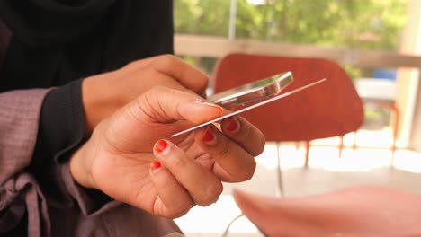 woman holding mobile phone and credit card