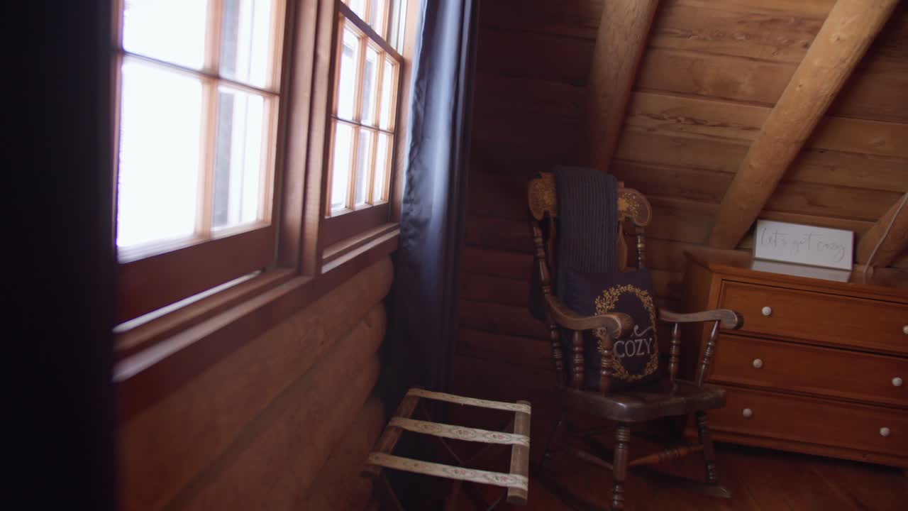 Cozy Log Cabin Interior Pan to Reveal Rocking Chair and Window with Light Rays