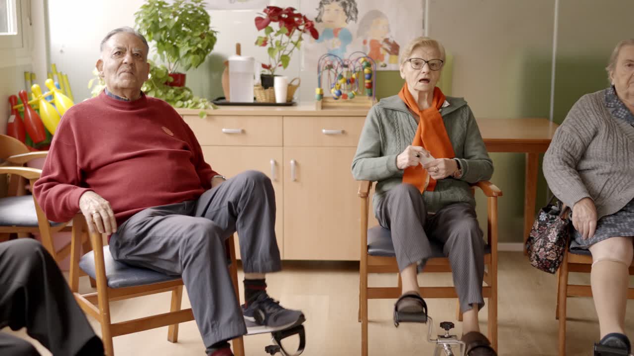 Elderly people pedaling while sitting in a nursing home