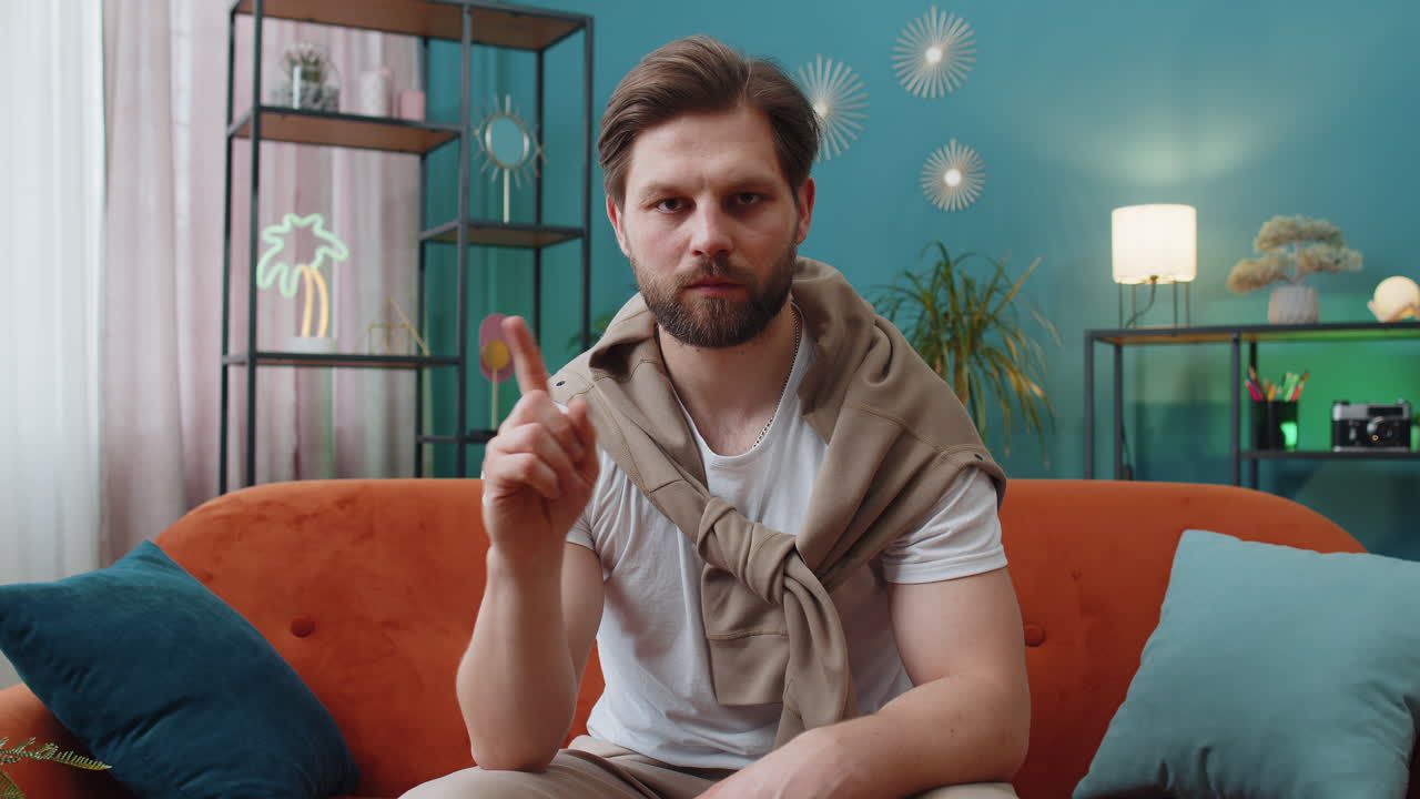 Displeased young man reacting to unpleasant awful idea dismiss bad idea wave hand shake head no