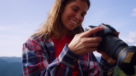 Hiker-using-professional-camera-in-mountains