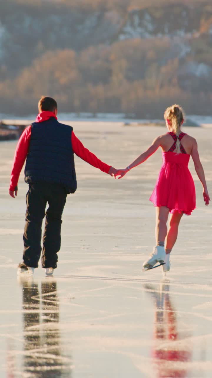 Captivating Moment on Ice: A Couple Skating Together Hand in Hand, Creating Unforgettable Memories on a Beautiful Winter Day While Gliding Gracefully Across the Frozen Surface of a Scenic Lake
