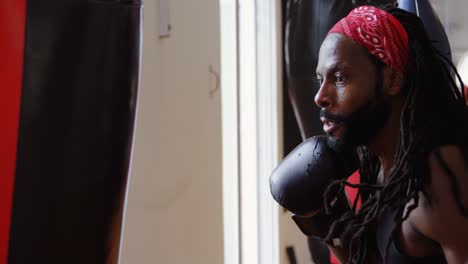 male boxer practicing boxing in fitness studio 4k