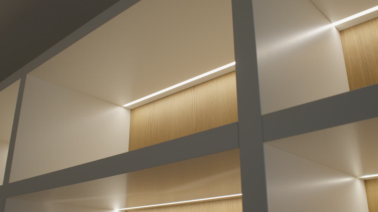 High quality video of a modern living room shelf with warm backlighting showing books art pieces and decor in a clean elegant interior space