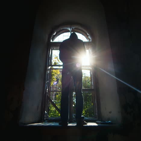 teenager with a gun sits in an abandoned building 1