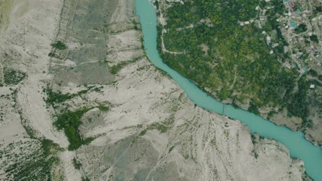 aerial view of a turquoise river flowing through a valley
