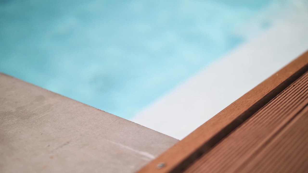 Detail of teca wood on a luxury swimming pool in summer on travelling