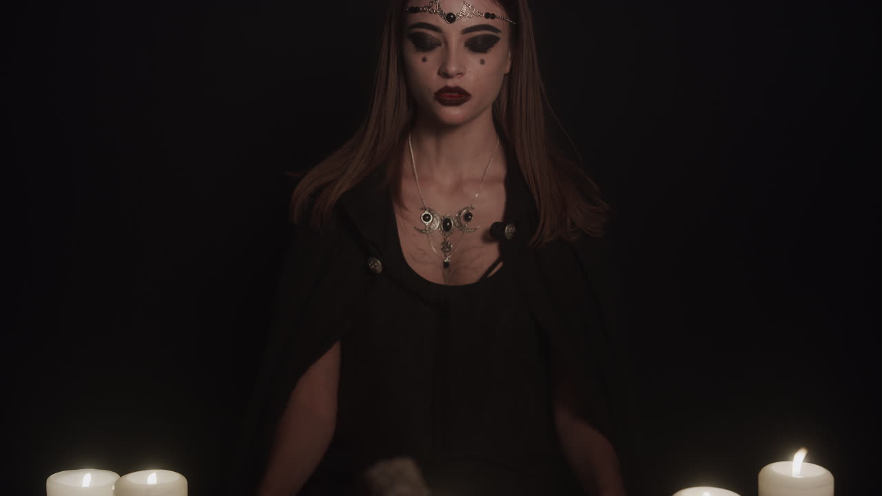 Wiccan Young Woman Priestess Stands at Altar with Eyes Closed Performs Ritual