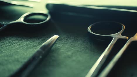 surgical medical instruments laid out on green linen close-up slide reveal