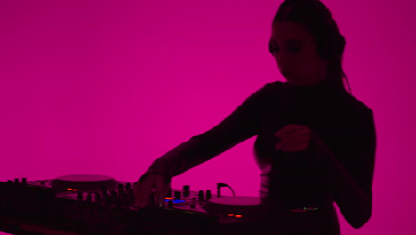 female dj mixing music on console