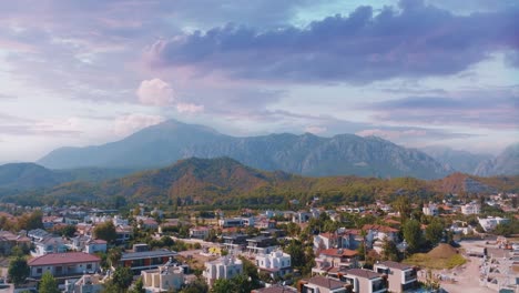 aerial view of a mountainous coastal town at sunrise/sunset