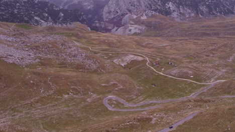 car driving at durmitor national park montenegro road beautiful valley surrounded by beautiful mountains, aerial