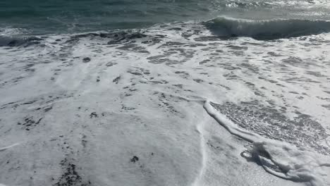 waves from the shore, under a blue sky.