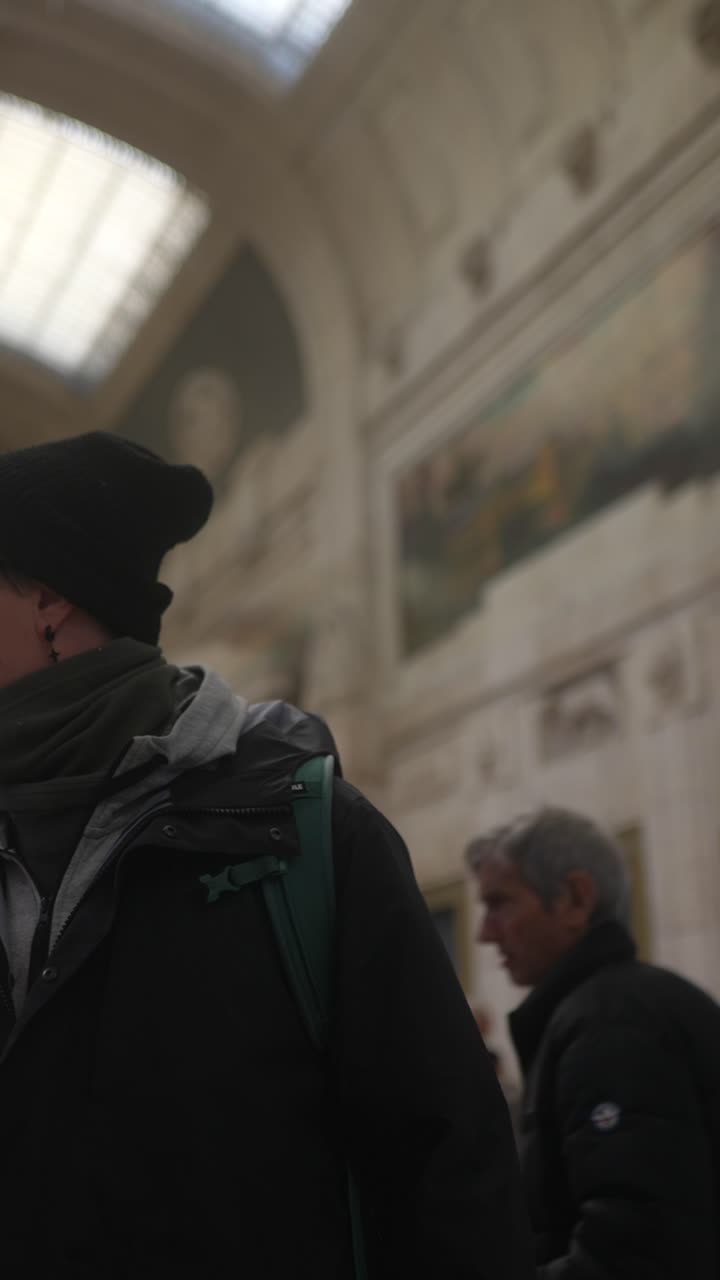 Person at train station looking at a phone