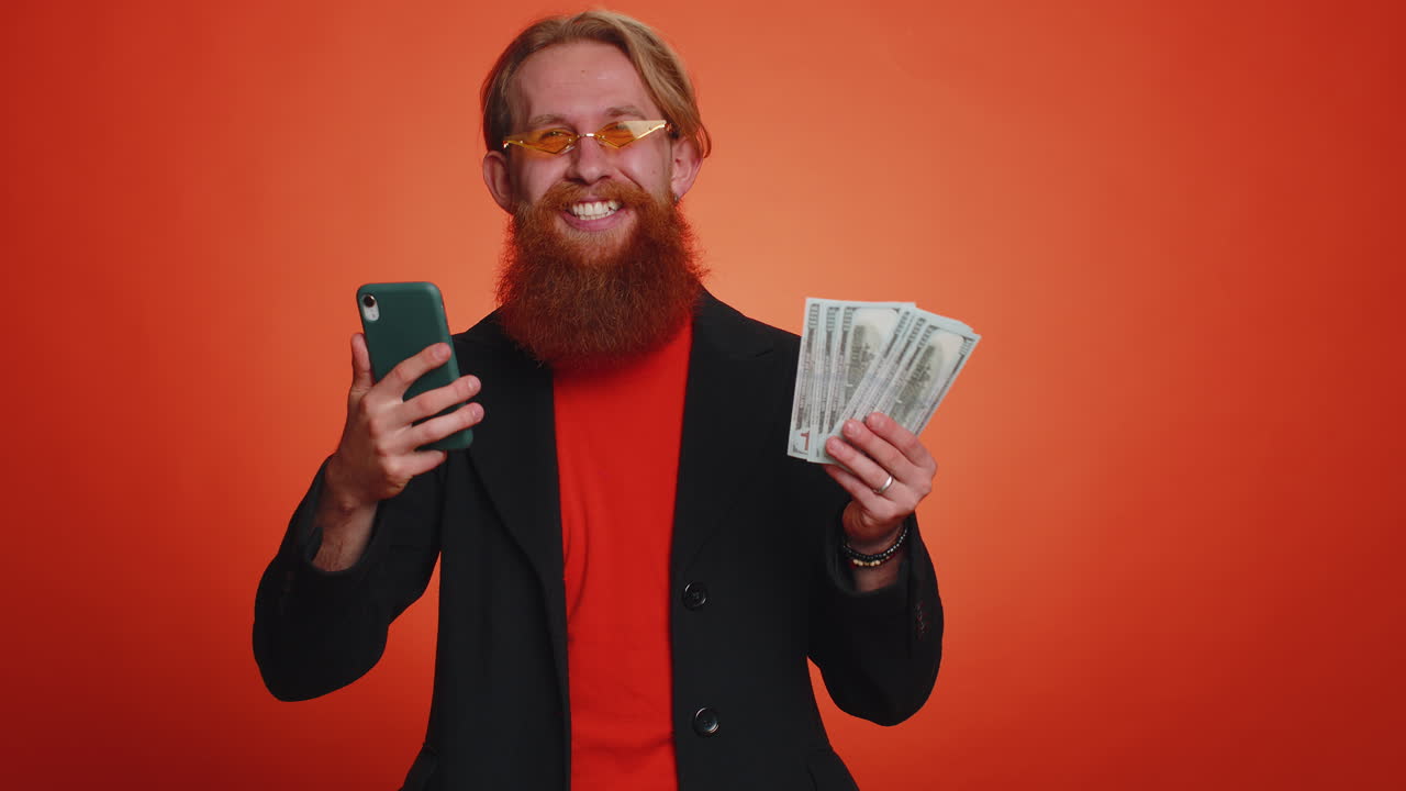 Happy tourist man use smartphone rejoicing win, receiving money dollar cash, success lottery luck