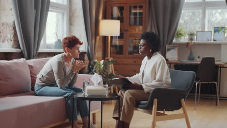 caucasian woman on therapy session with african american psychologist