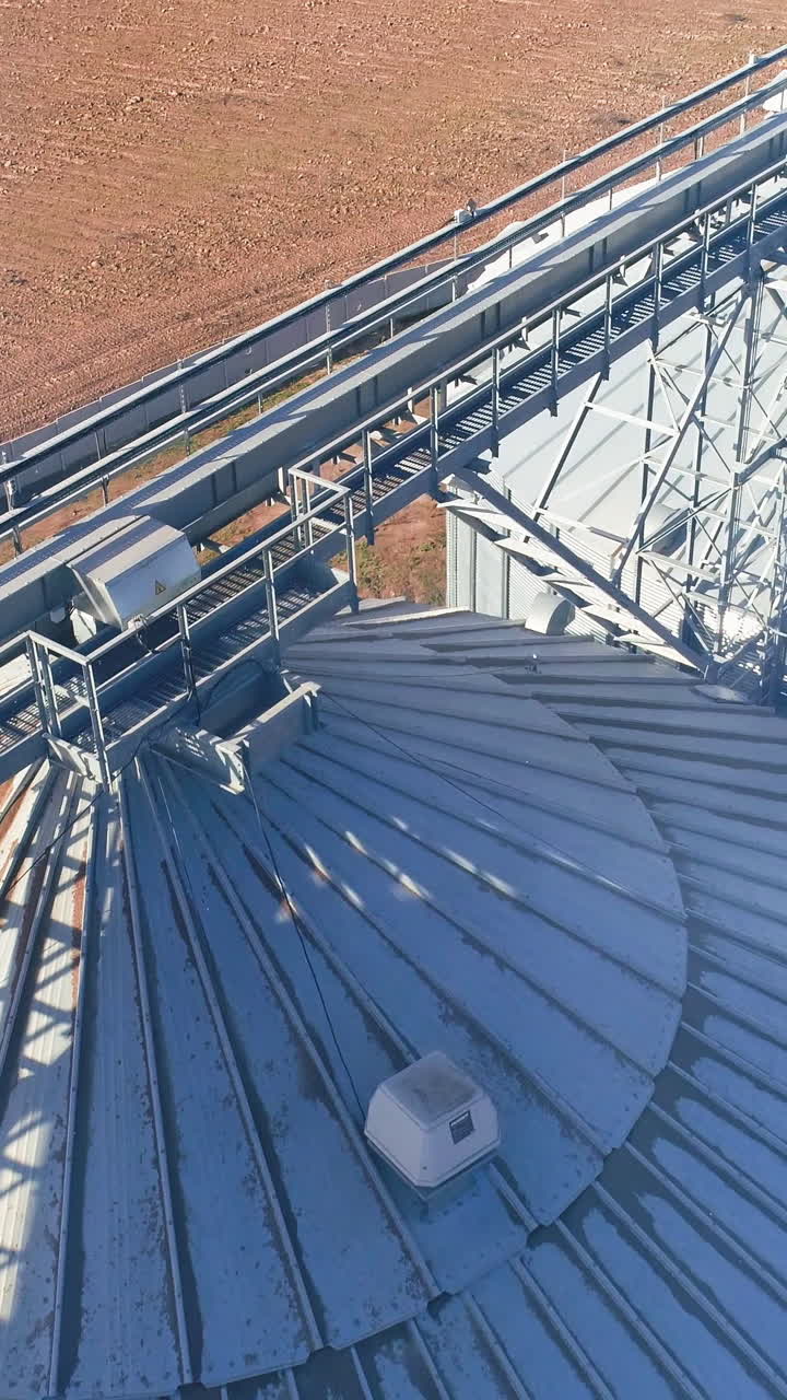 Farming elevator and granary. Storage of grain and other different cereals. Aerial view Vertical video