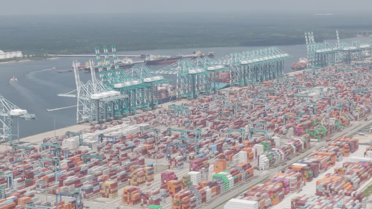 Aerial lateral shot of Tanjung Pelepas port showing container yards and cranes captured in dlog m color profile