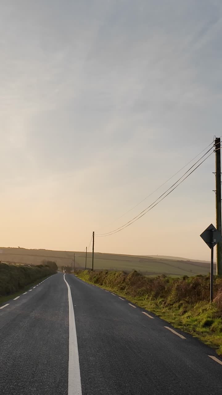 Straight line on the road and driving with morning sun. Rural Ireland. Left side driving