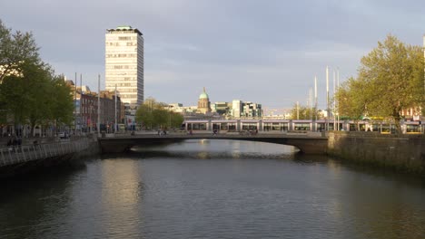 siptu headquarter at liberty hall with tram crossing rosie hackett bridge in dublin, ireland