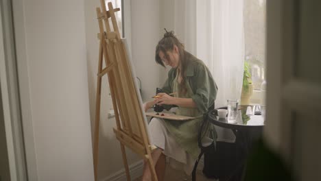 woman painting at home