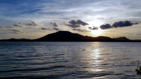 beautiful sunset scenery with water, lake, clouds and sky