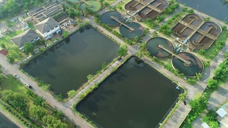 aerial view top down of wastewater treatment plant with round ponds for recycle dirty sewage water