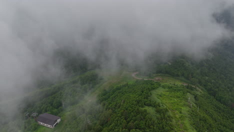 Aerial-view-diving-under-low-clouds-in-the-Shiga-Highlands-of-Japan