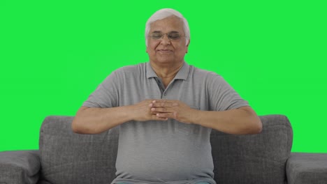 Happy-Indian-old-man-doing-breathe-in-breathe-out-exercise-Green-screen