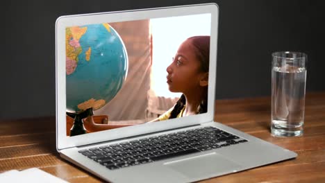 animación de una computadora portátil que muestra a una chica de raza mixta mirando un globo en la pantalla