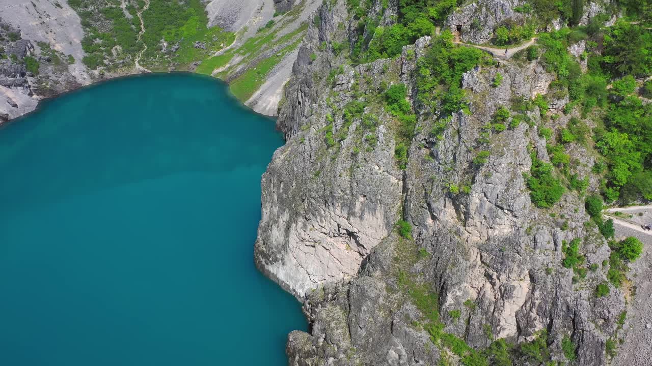 Aerial shot of Blue Lake lying in a deep sinkhole near Imotski town, Croatia