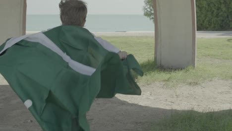 child holding saudi arabia's flag and running 4k