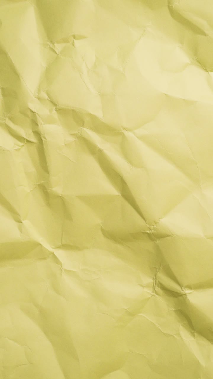Yellow crumbled paper loop animation. Old, textured, and retro feel for covers, motion graphics, or background layers.