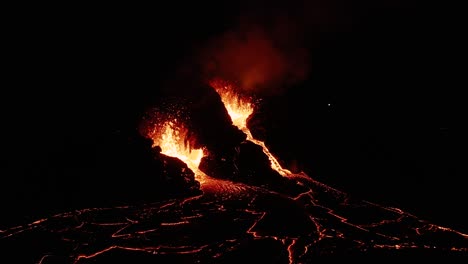 nighttime at active effusive volcano with exploding magma from earth mantle