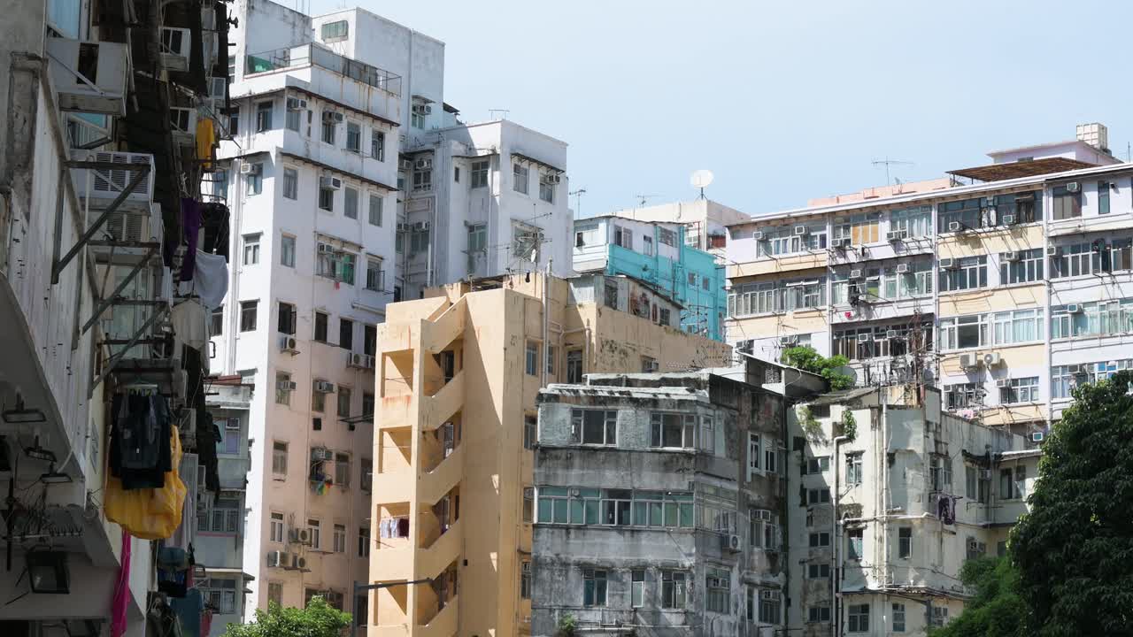 Residential buildings in a densely populated, low-income neighborhood of Hong Kong, China, highlighting urban housing conditions.