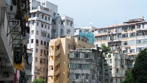 residential buildings in a densely populated, low-income neighborhood of hong kong, china, highlighting urban housing conditions.