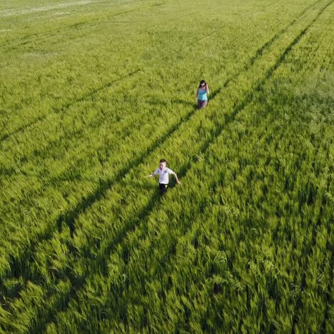 small family walking in field