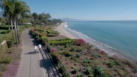 aerial shot of bicyclists on a pathway above butterfly beach in montecito santa barbara california