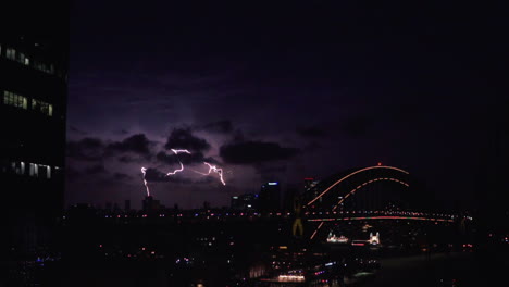 lightning over sydney harbour bridge and central business district of sydney in new south wales, australia. - wide shot