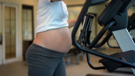 active pregnant woman exercise in fitness center.